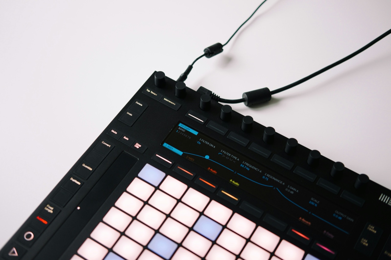 Close-up of a MIDI pad controller with illuminated pads